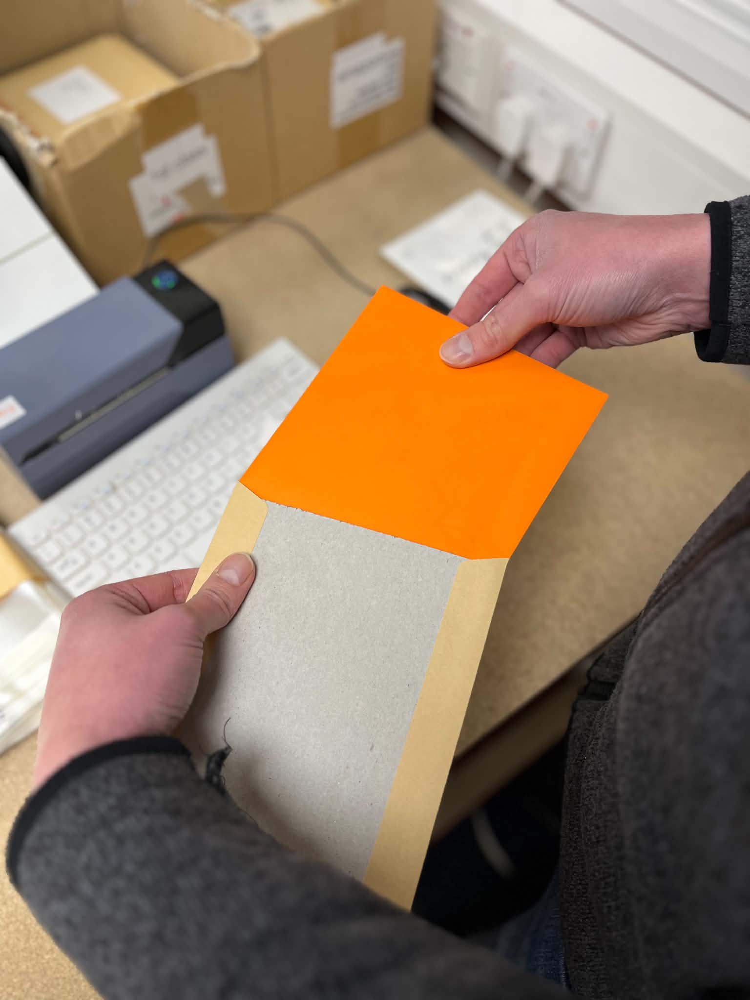 A Connect card with an inner message being placed inside a coloured envelope
